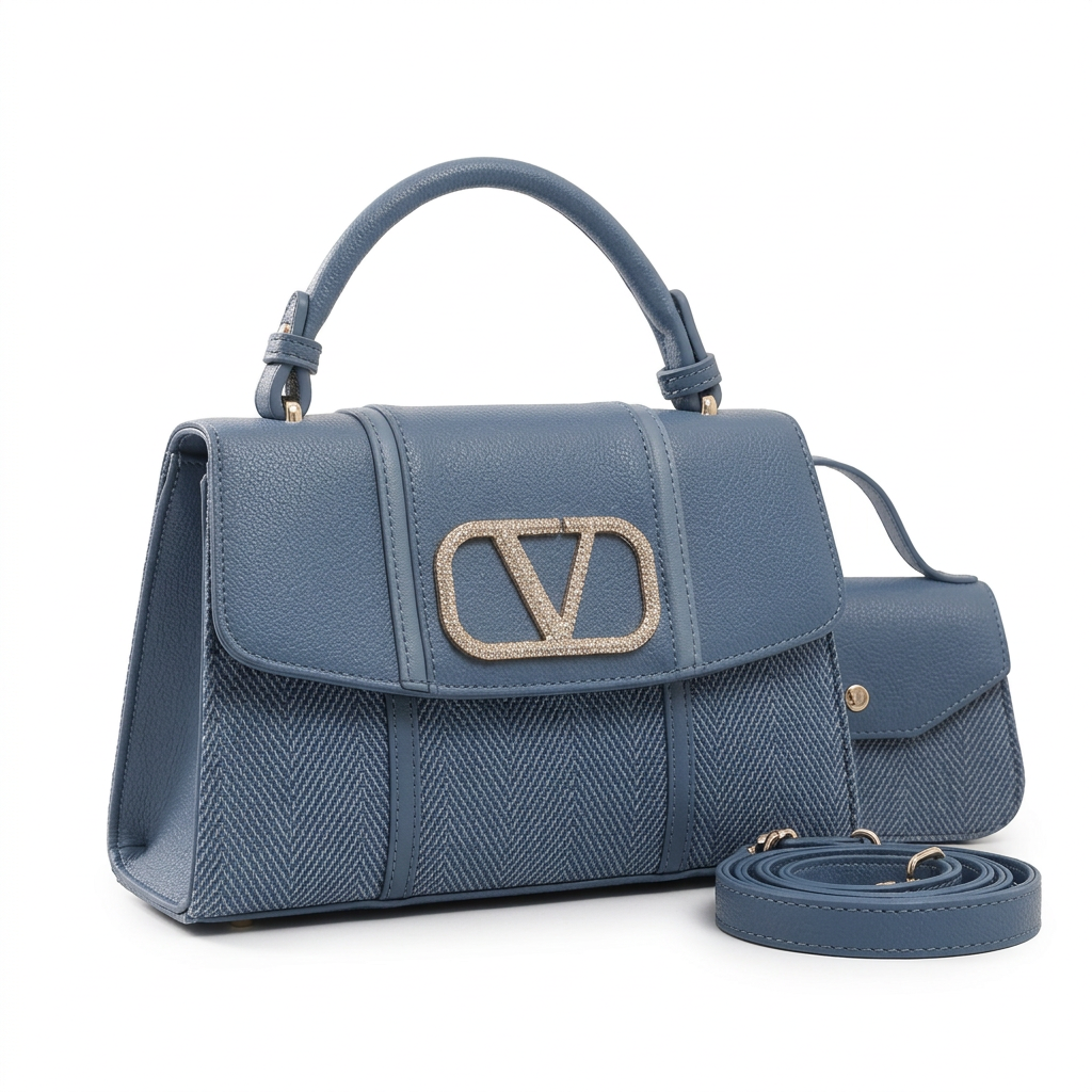 Slate blue herringbone-panel top-handle handbag beside smaller button-flap bag and coiled strap