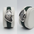 Asymmetric silver skeleton dial watch with forest green strap front and side view