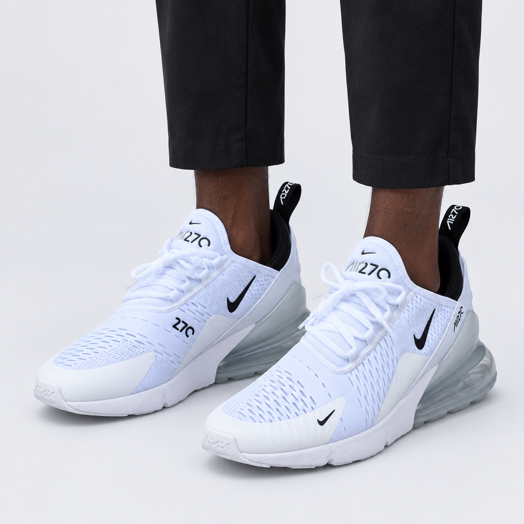 Adult wearing white mesh lace-up sneakers with black details