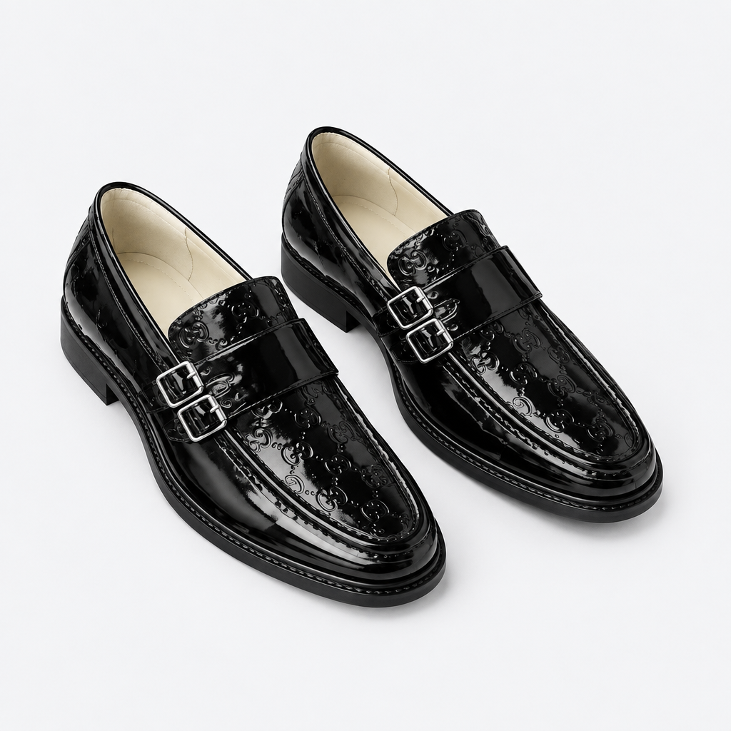 Black men's embossed double-buckle loafers shown as a complete pair