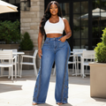 Curvy Nigerian female model wearing blue high-waist wide-leg rhinestone floral jeans