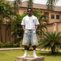 Nigerian male model wearing men's light blue distressed leopard pocket lining wide-leg denim shorts streetwear style