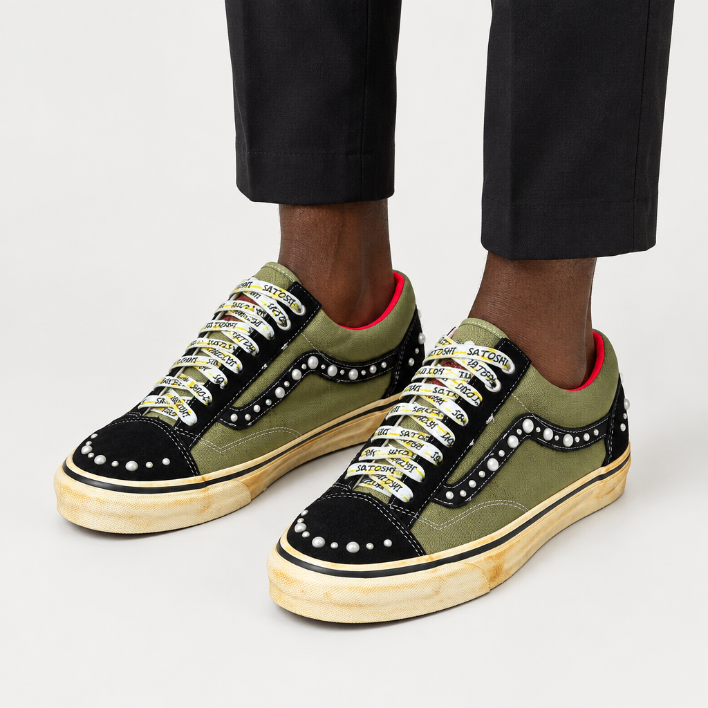 Adult wearing olive-and-black embellished lace-up sneakers