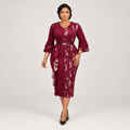 Black Nigerian model wearing a burgundy floral midi gown with ruffle sleeves and a belted waist