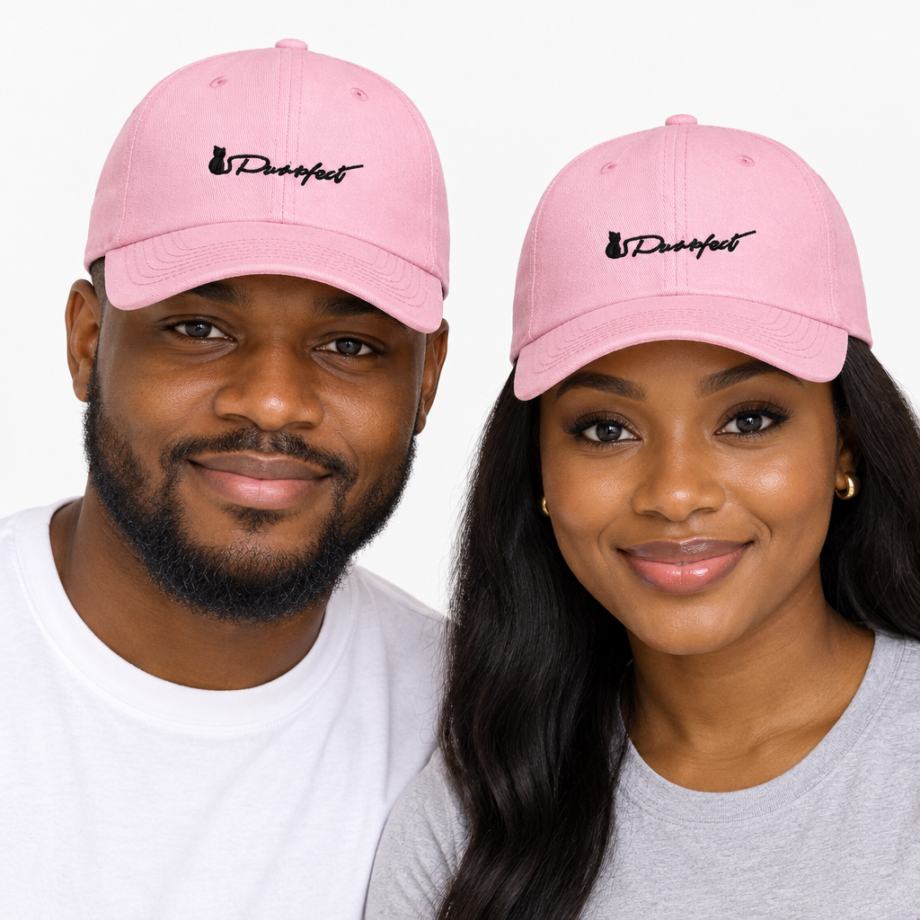 Man and woman together wearing matching pink embroidered baseball caps