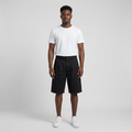 Full-body male model wearing black pleated shorts