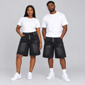 Woman and man together wearing charcoal-black denim shorts with silver-tone hook details