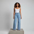 Nigerian female model wearing light blue wide-leg denim trousers