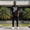 Nigerian male model wearing men's black spider graphic short-sleeve tee full body streetwear editorial shot