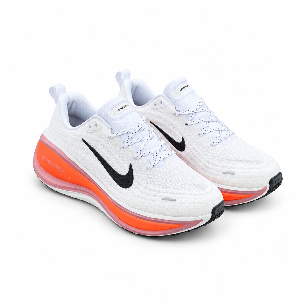 White lace-up sneakers with black side details and orange sole accents