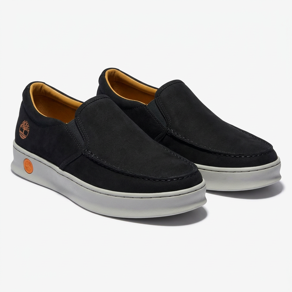 Matching black moc-toe slip-on shoes with light grey soles and orange heel accents