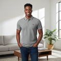 Young Nigerian male model wearing grey tipped polo shirt, front view