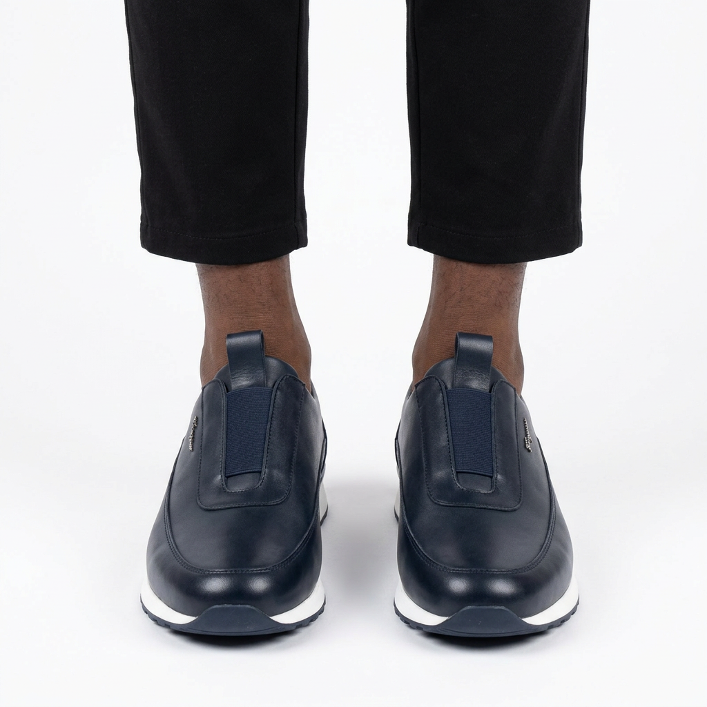Adult man wearing dark navy elastic-panel slip-on shoes