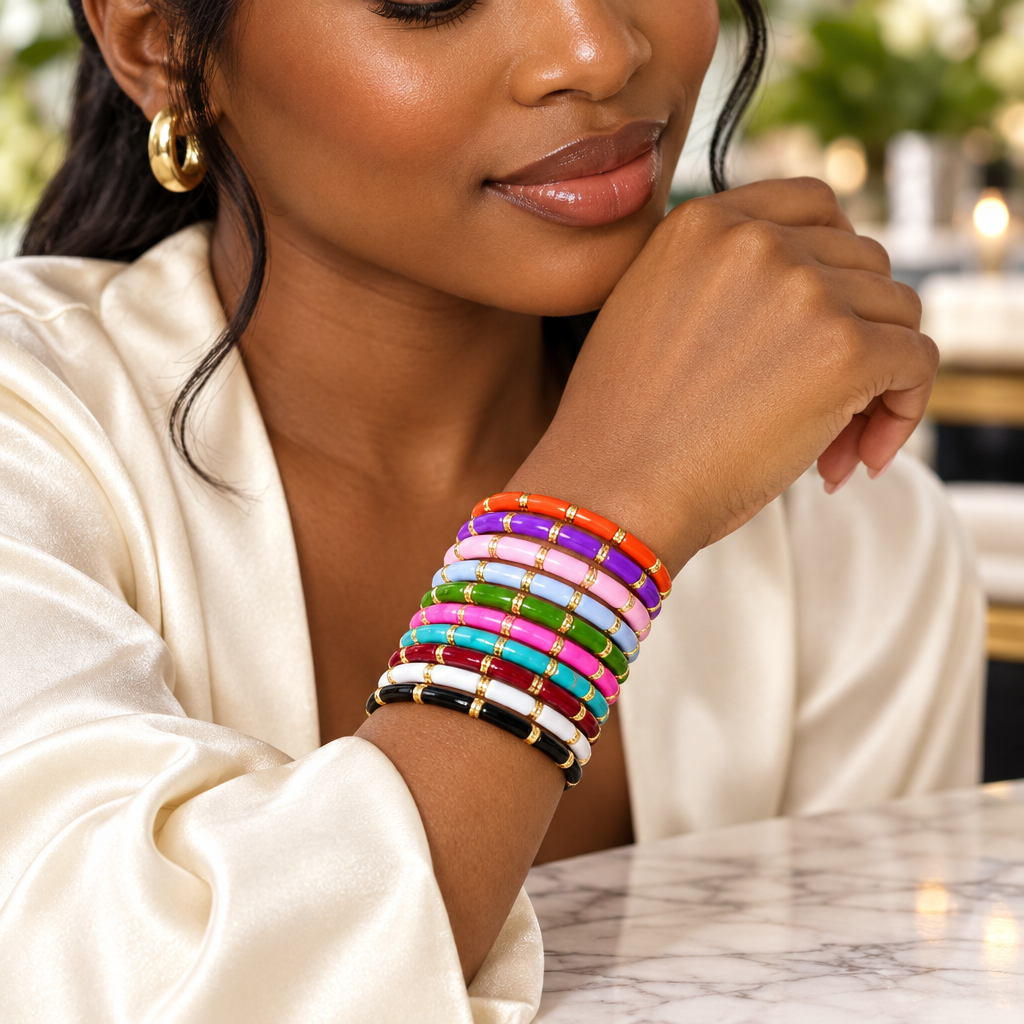Woman wearing a stack of colourful enamel tube stretch bracelets