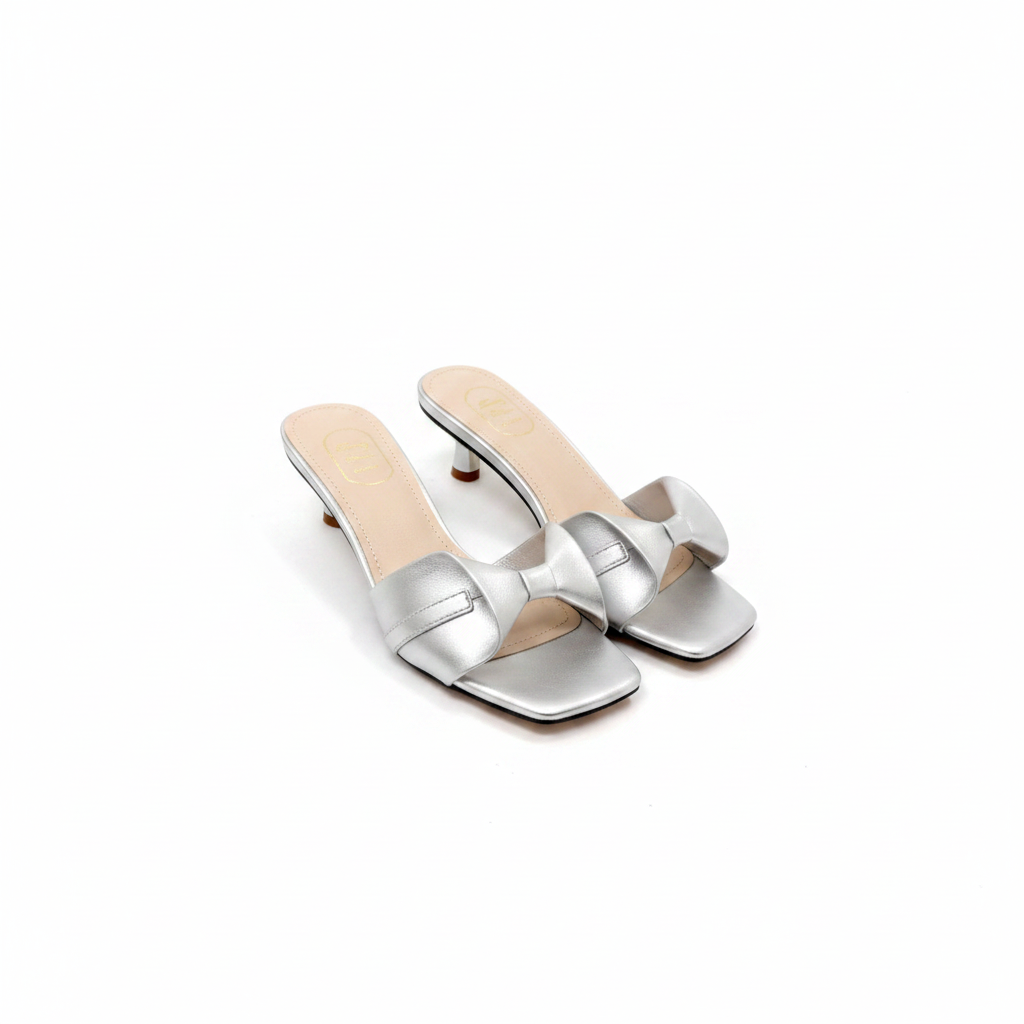 Ghost mannequin pair view of silver metallic crossover strap kitten heel slide mules