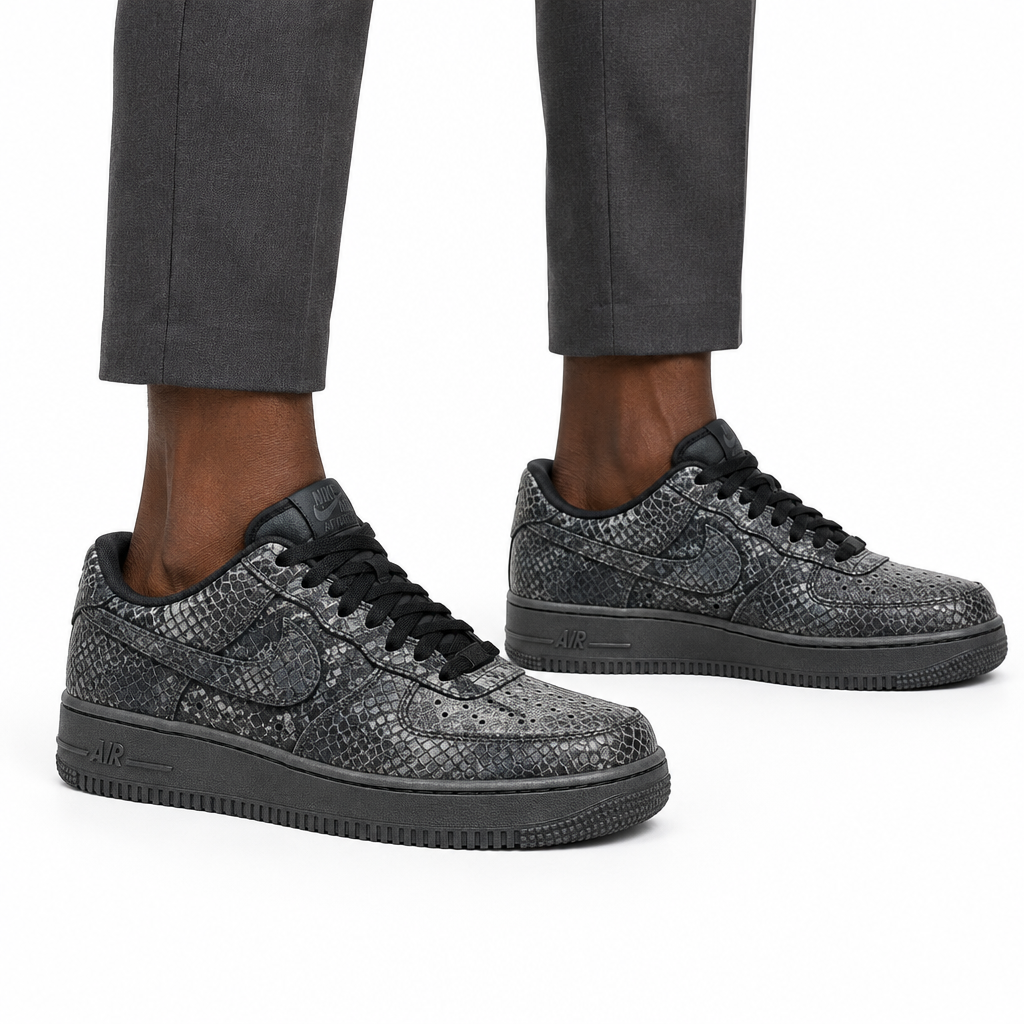 Man wearing charcoal textured sneakers, both feet visible