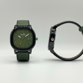 Olive-green dial watch with black case and green leather strap shown from the front and side