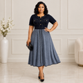Adult Black woman wearing black and grey flared dress