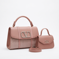 Dusty rose herringbone-panel top-handle handbag beside smaller smooth flap bag and coiled strap