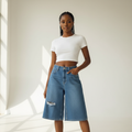 Blue ripped wide-leg denim shorts front view on model