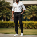 Nigerian male model wearing black slim trousers in outdoor setting