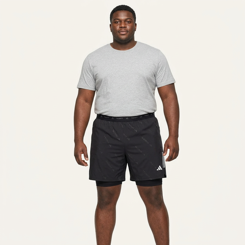 Model wearing black layered training shorts