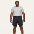 Model wearing black layered training shorts
