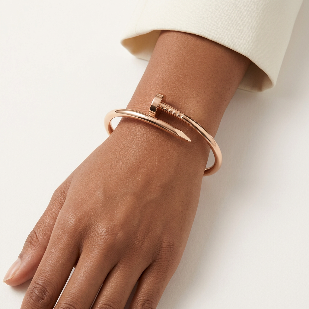 Rose-gold-tone nail-style bracelet worn on a model’s wrist