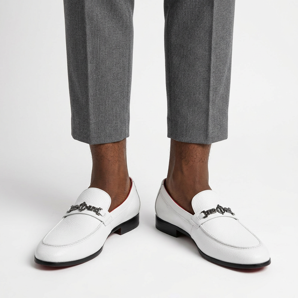 White geometric-detail loafers properly worn on both feet with grey trousers