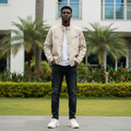 Nigerian male model wearing cream vintage embroidered bomber utility jacket