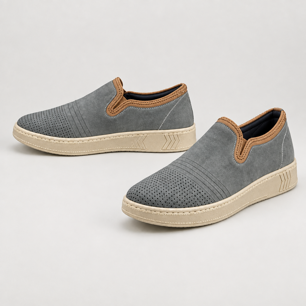 Men's grey slip-on sneakers with perforated toes, tan trim, and cream soles