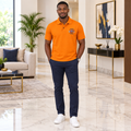 Man wearing orange piqué nautical badge polo shirt