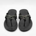 Pair of black overlap-strap toe-post slides on white