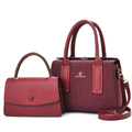 Burgundy textured twin-handle handbag pictured beside smaller burgundy flap bag