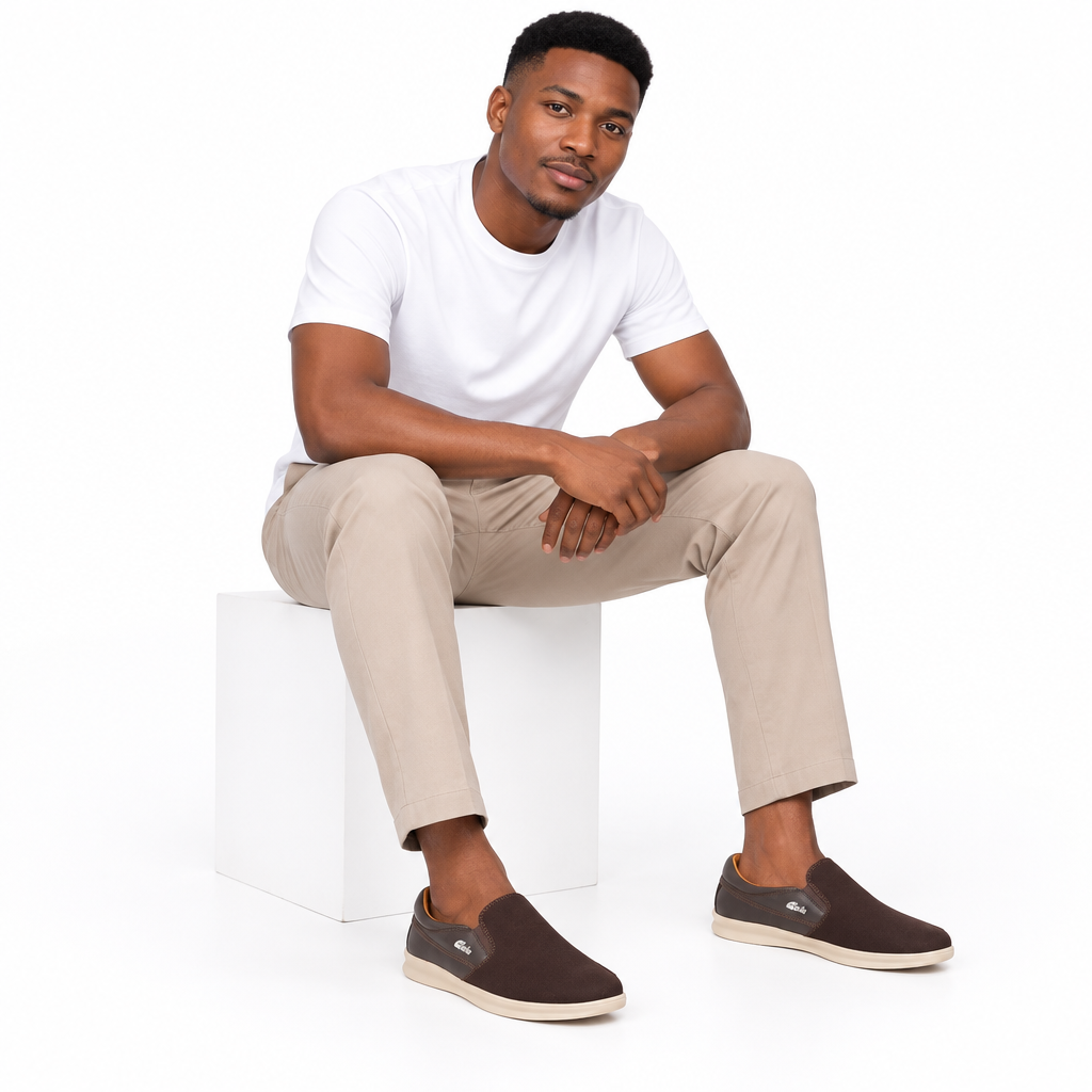 Both brown slip-on shoes worn on plain white background
