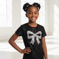 Young girl wearing black rhinestone crystal bow T-shirt