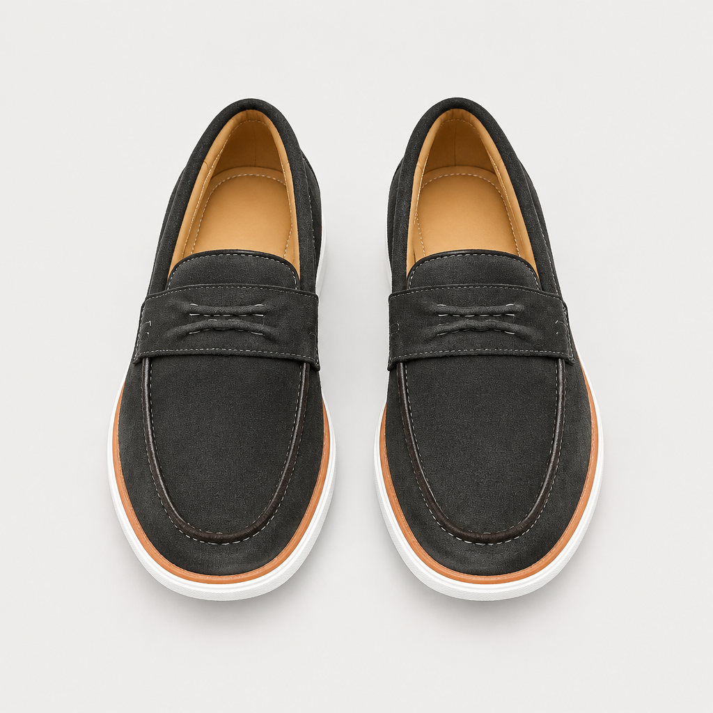 Pair of dark charcoal suede loafers with tan trim and white soles