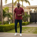 Nigerian male model wearing maroon crew neck t-shirt outdoors
