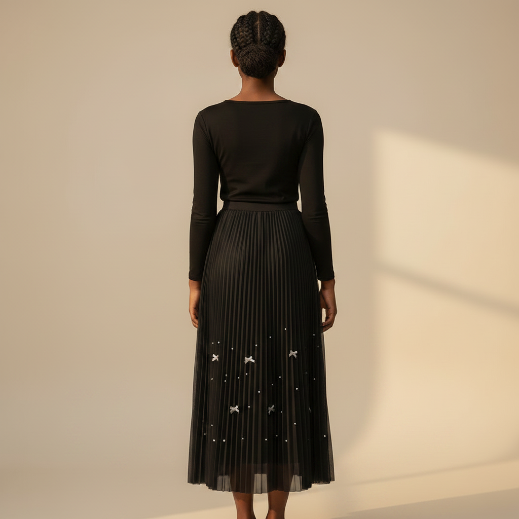 Nigerian girl wearing black bow pleated midi skirt - back view