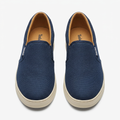 Straight-on navy textured slip-on sneakers with light cream soles
