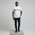 Nigerian male model wearing white tropical beach print short-sleeved shirt, front view