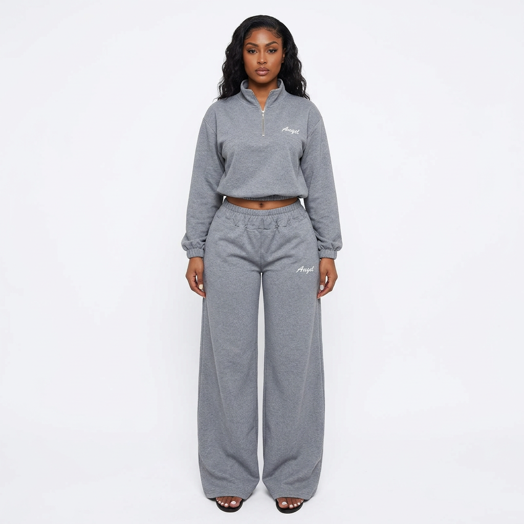 Adult Black model wearing a grey quarter-zip top and wide-leg trouser set