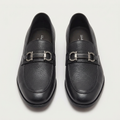 Straight-on view of black textured loafers aligned side by side with silver-tone hardware