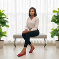 Nigerian female model seated wearing red croc-embossed patent ballet flats with double-bar buckle detail