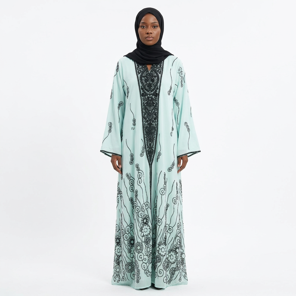 Single Nigerian woman wearing the mint black-scroll panel abaya