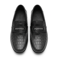Front view of a pair of black croc-effect loafers with silver-tone vamp details