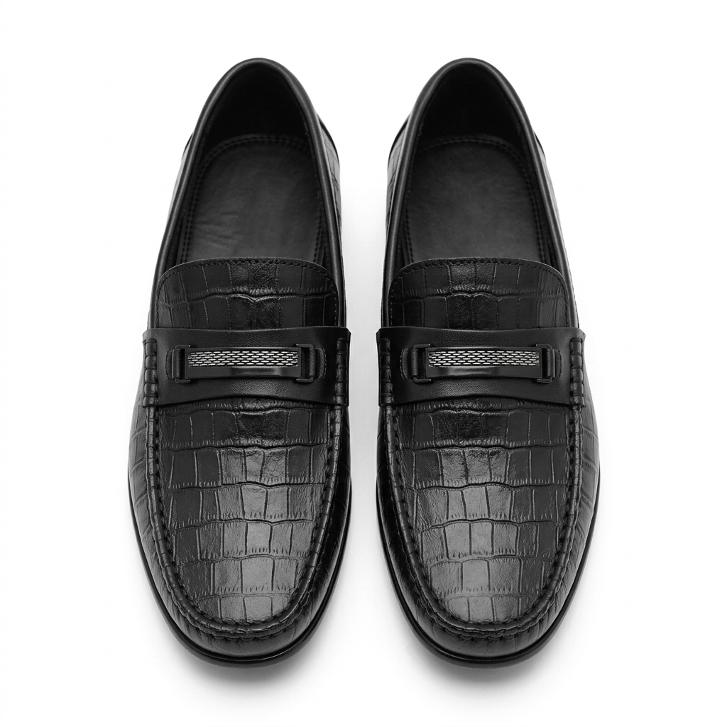 Front view of a pair of black croc-effect loafers with silver-tone vamp details