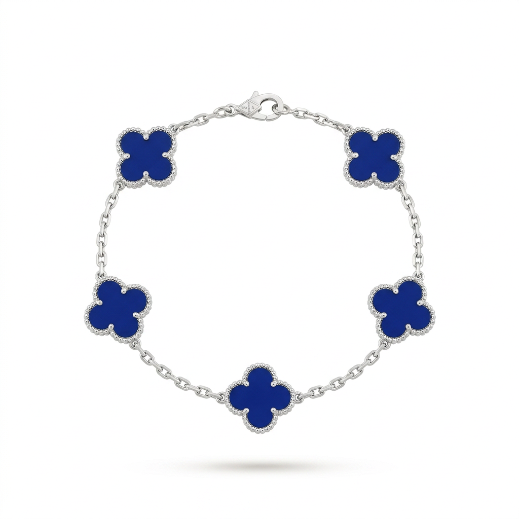 Silver-tone bracelet with five blue inset clovers on white