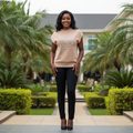 Nigerian female model wearing beige pearl swirl embellished knit top - front view