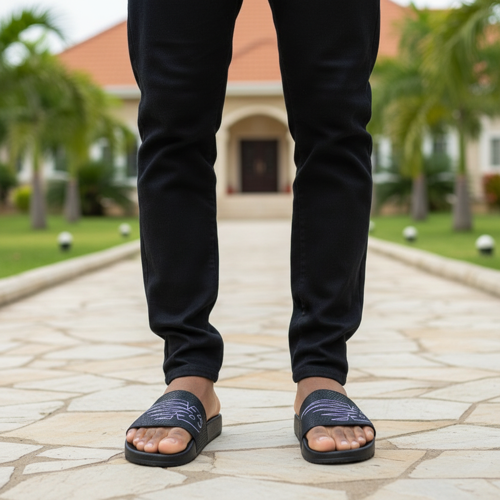Nigerian male model wearing black abstract graphic print slide sandals leg focus shot